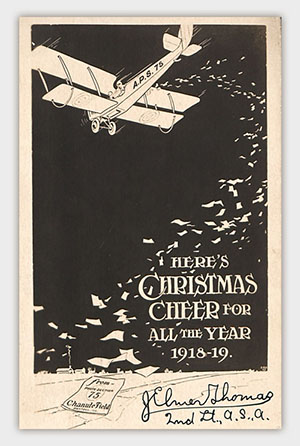 Image: Print of a WWI-era biplane scattering Christmas cards. Text: Here's Christmas Cheer for All the Year 1918-19.