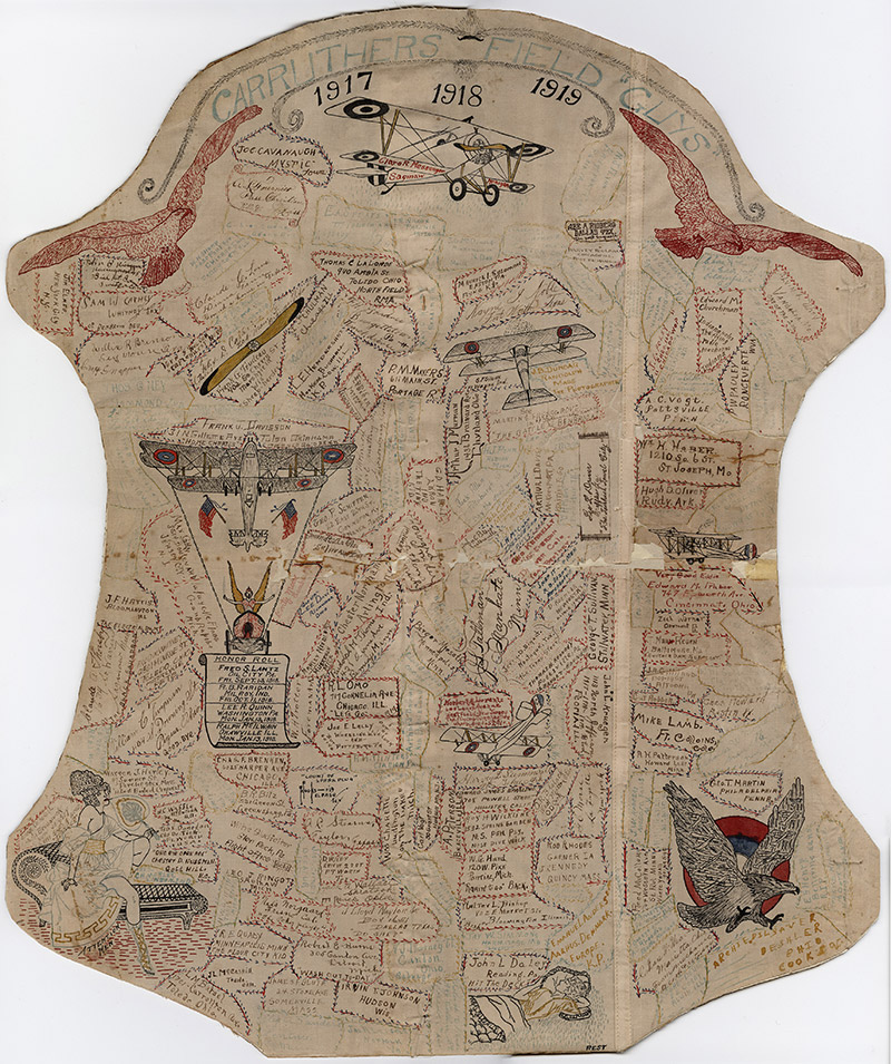 Airplane fabric fragment covered in pen signatures and drawings