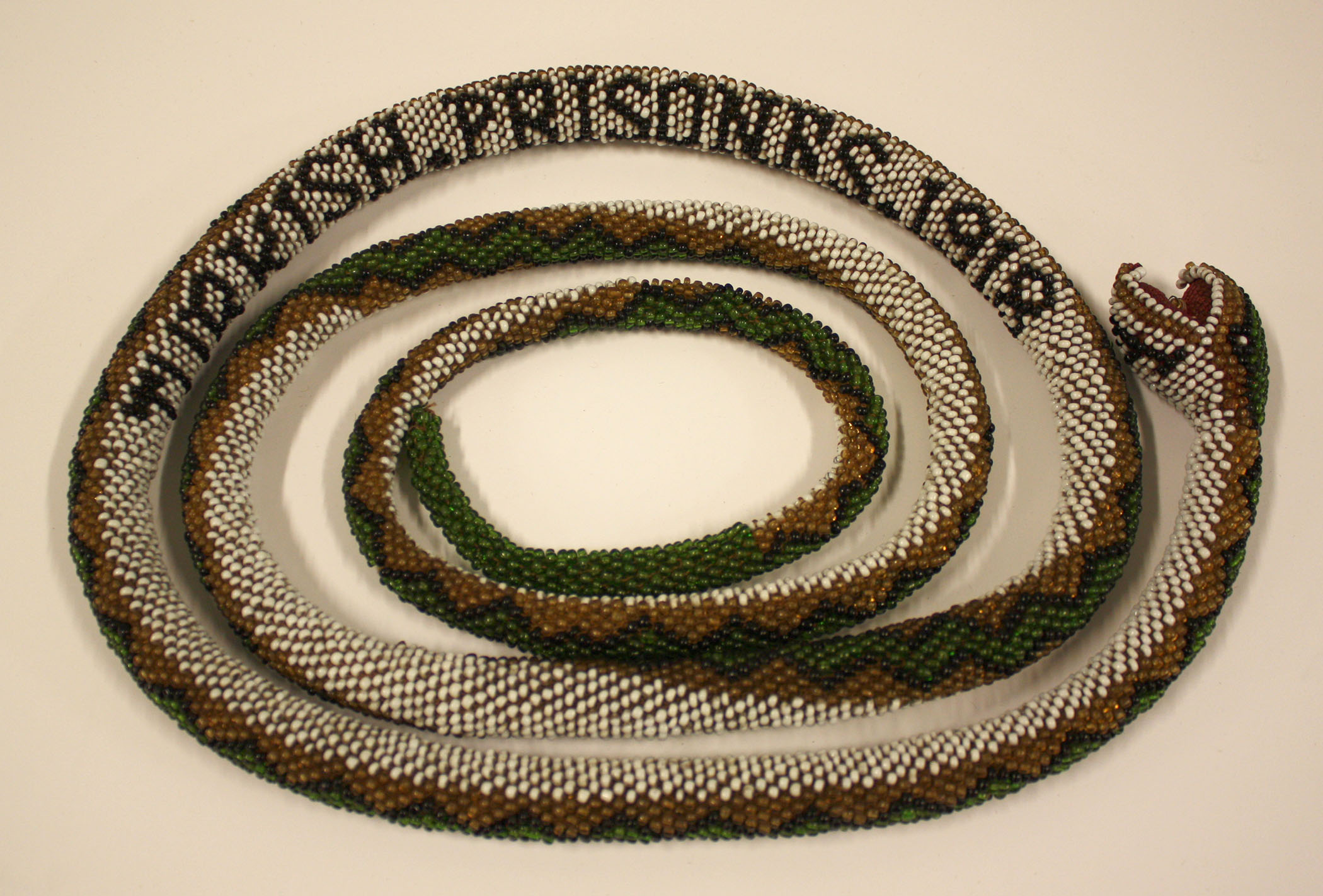 Photograph of a beaded cloth snake