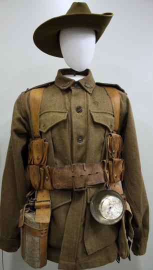 Photograph of a WWI-era combat uniform with utility belt and wide-brimmed hat