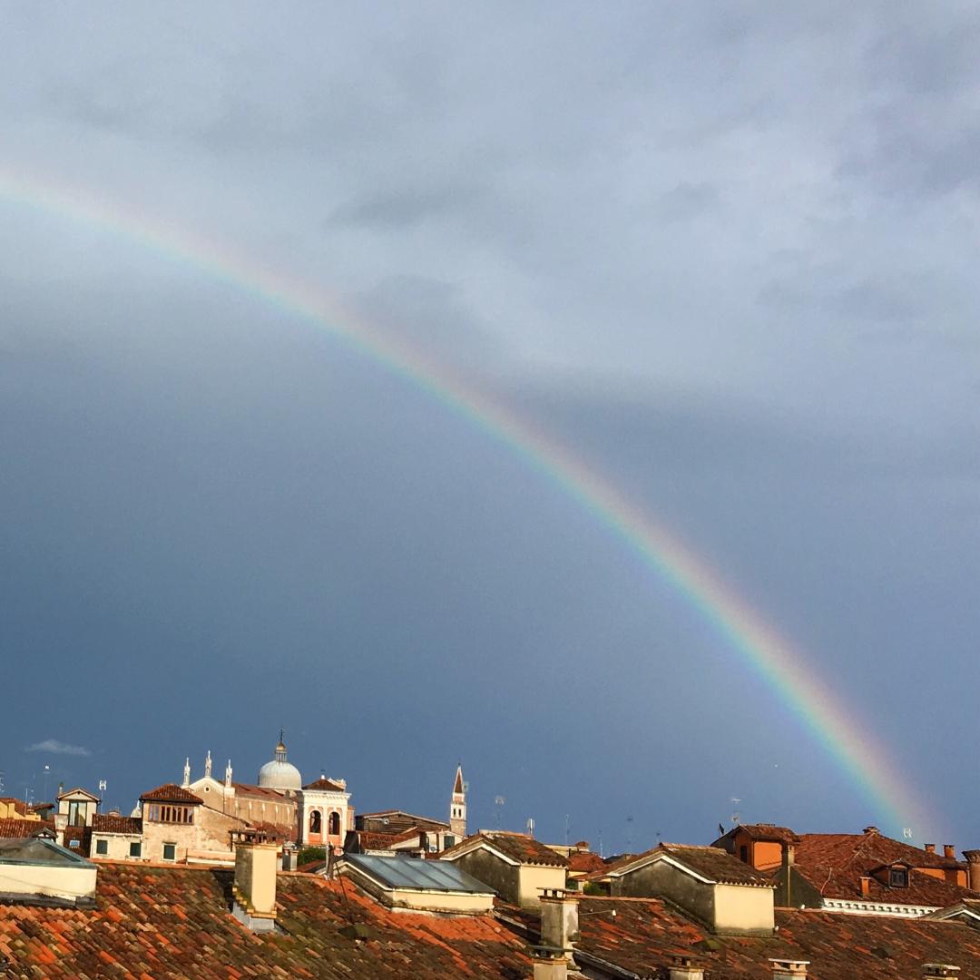 A rainbow above a traditional Italian cityscape