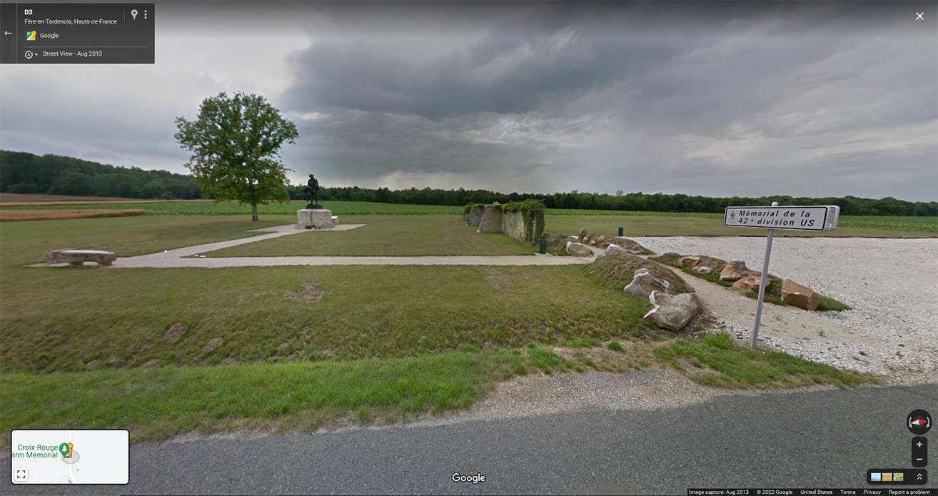 Google Street View of a small park-like area with a lone tree.