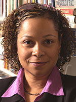 Headshot of a Black woman with short curly hair wearing a black suit jacket and purple button-down shirt
