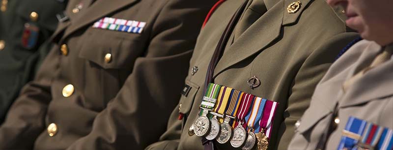 Close up of soldiers in uniform, showing medals on chests