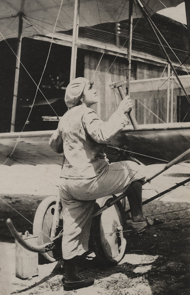A French woman working as an airplane mechanic.