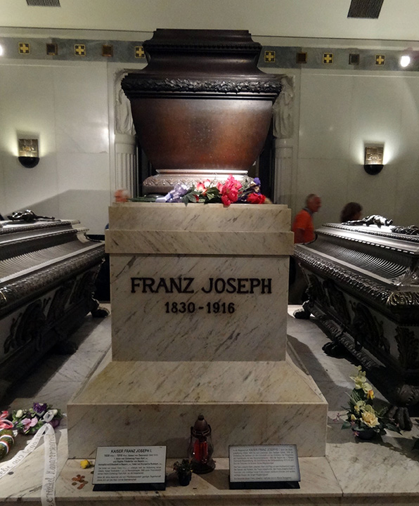 Marble casket on a marble plinth inside a marble room. Engraved on the casket: 'Franz Joseph / 1830-1916'