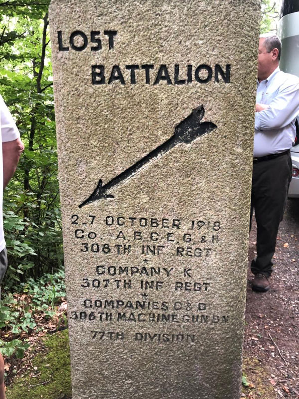 Large stone marker engraved with the words 'Lost Battalion' and an arrow pointing downwards.