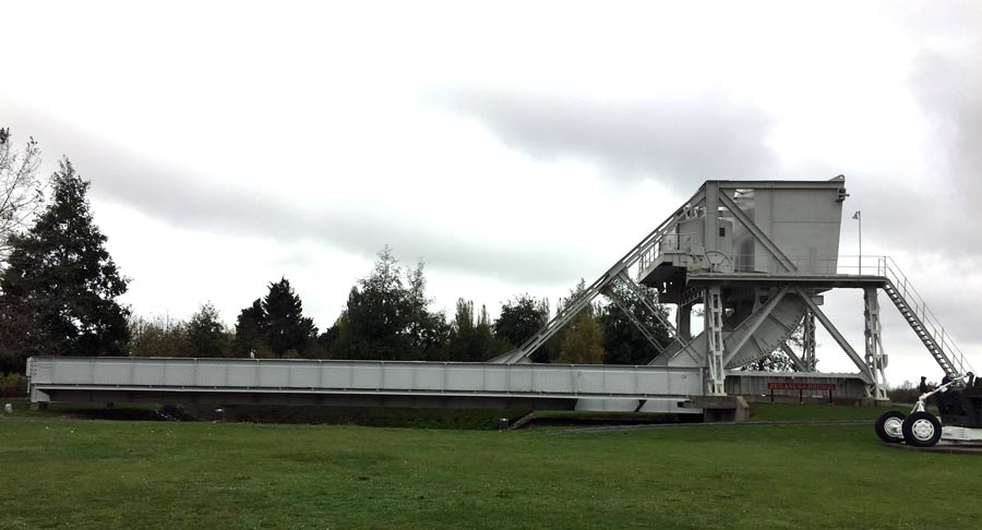 Large metal bridge displayed on a lawn