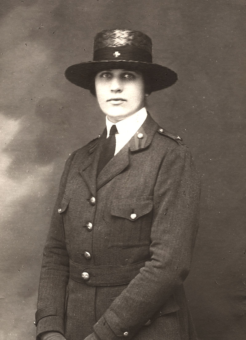 Black and white portrait of a young white woman in uniform with a wide-brimmed hat