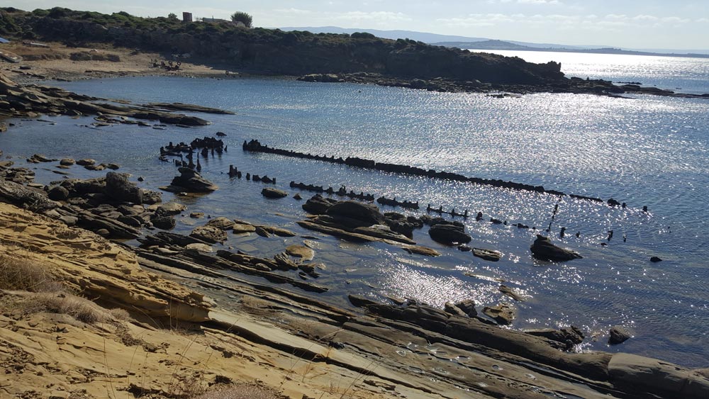 View of an ocean bay with rocks in the water