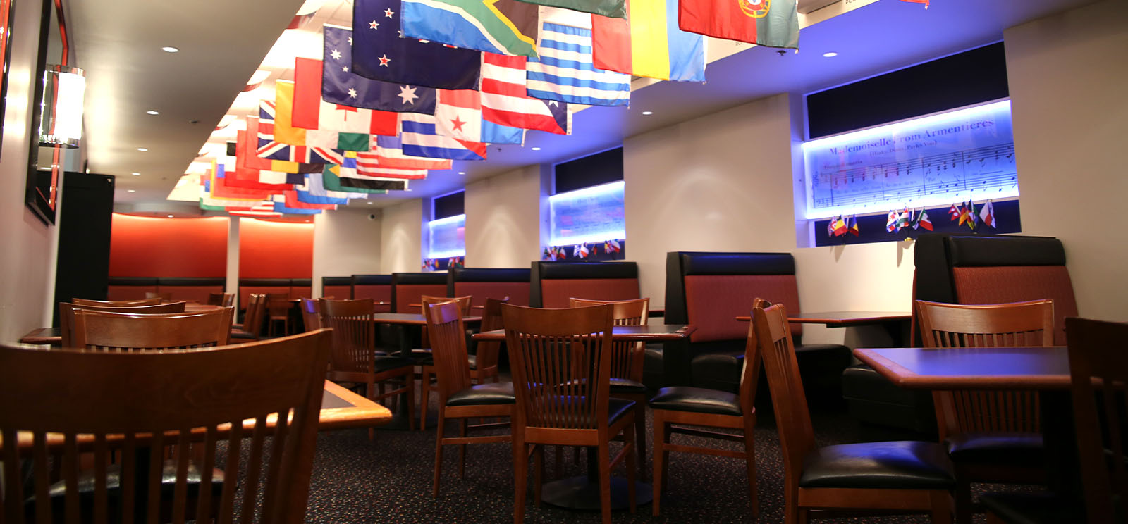 Seated area of the museum cafe. Flags of many nations hang from the ceiling