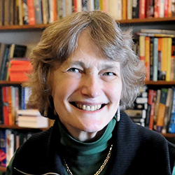 Headshot of an older white woman with short wavy silver-blonde hair