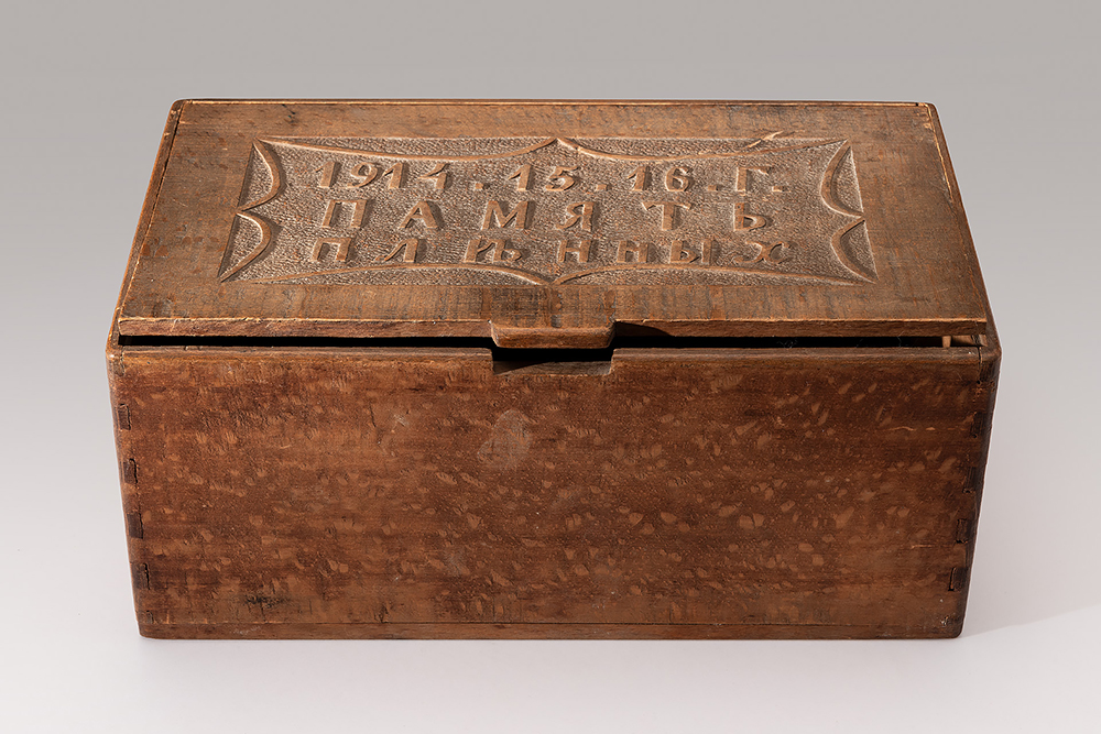 Modern photograph of a wooden box with Cyrillic words carved on the lid