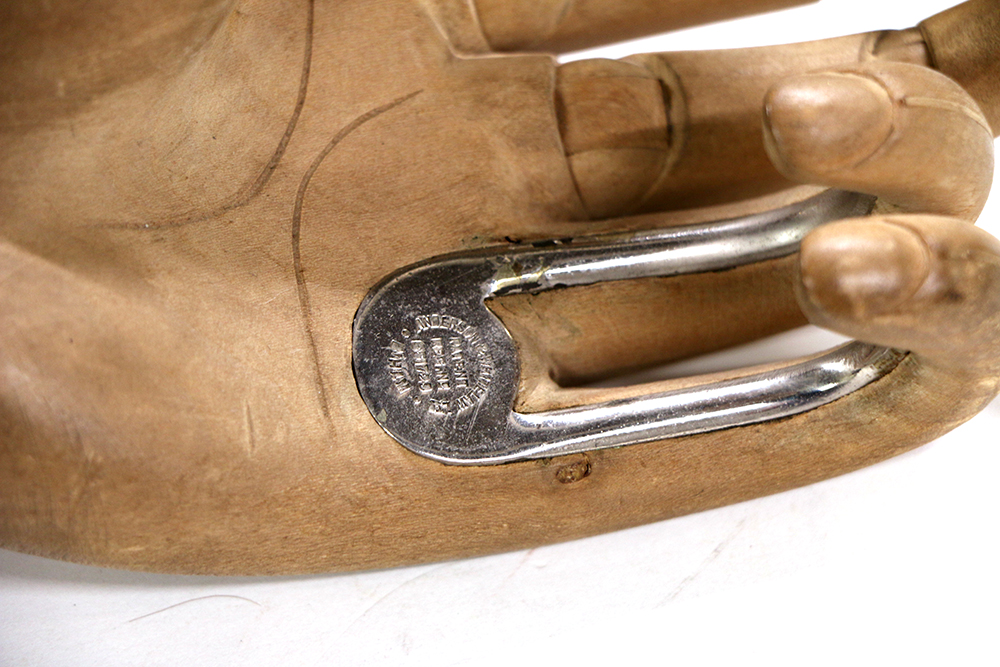 Modern photograph - closeup on the palm and curved fingers of a wooden artificial hand