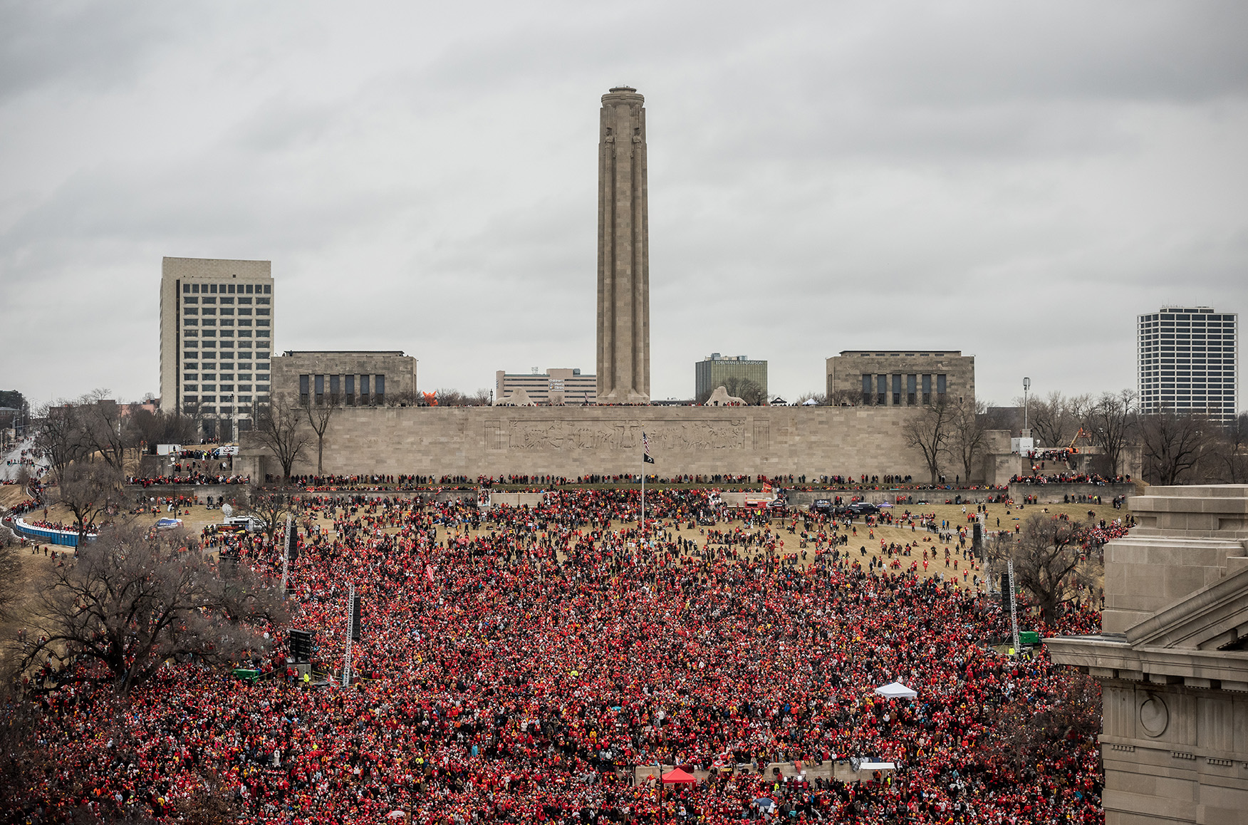 Modern photograph of the North Lawn of the Museum and Memorial grounds with the Liberty Memorial Tower in the background. The entire area is filled with a huge crowd dressed in red.