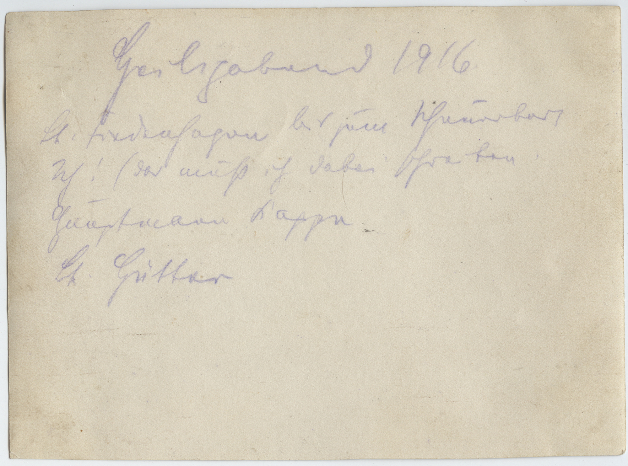 Back of an old photograph with cursive German writing in faded ink.