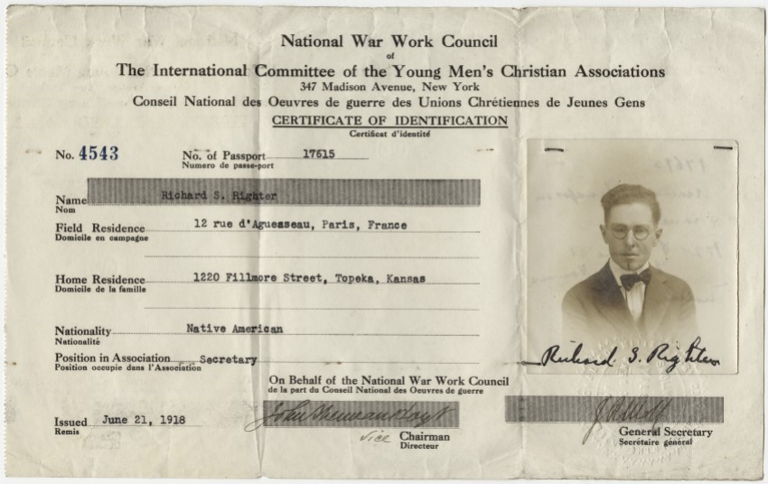 Scan of a work passport with typed information and a small picture of a young short-haired man wearing glasses, a jacket and bowtie