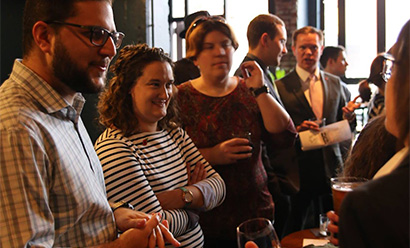 Modern photo of a gathering of stylish young people chattering with each other in a bar