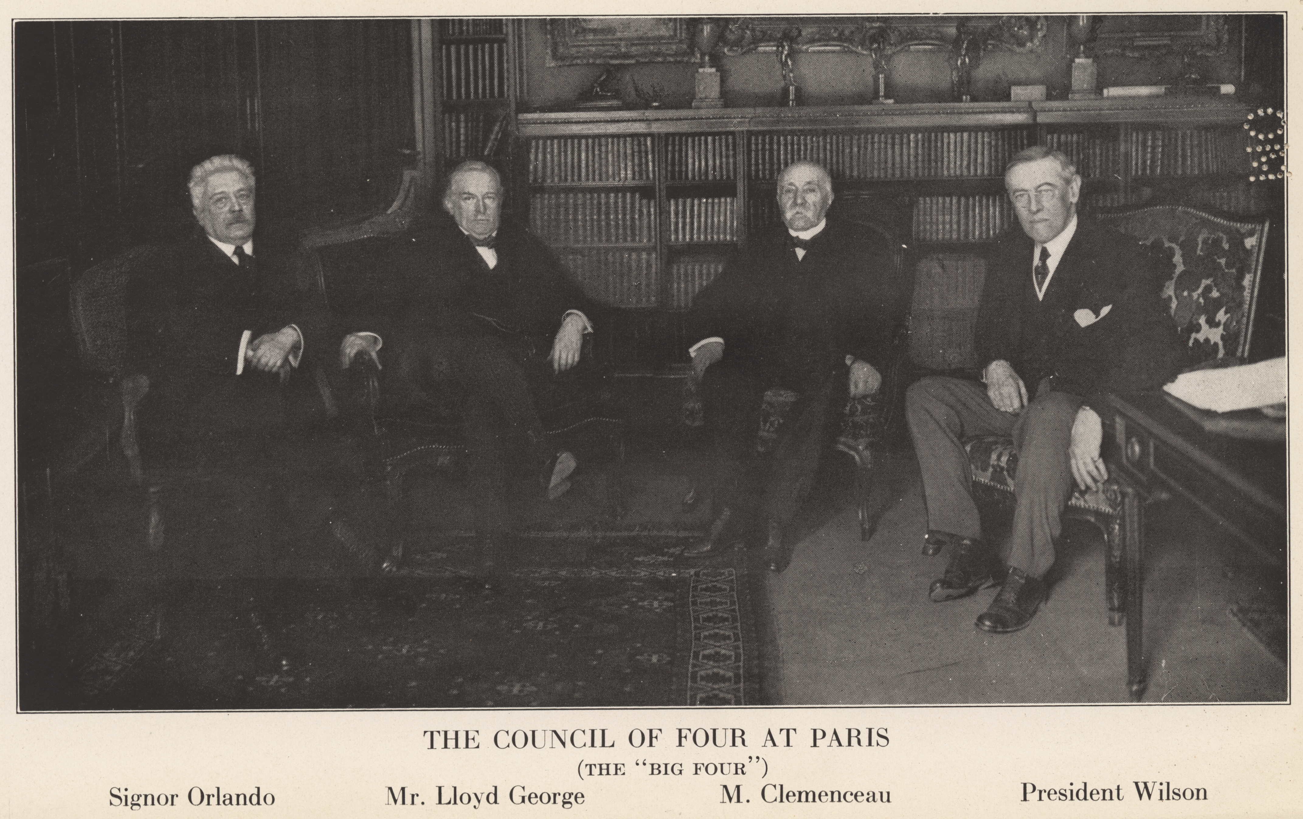 Photograph of four older men, sitting in a room filled with books and fine decor. The image is captioned with "The Council of Four at Paris" and lists the names, "Signor Orlando", "Mr. Lloyd George", "M. Clemenceau", and "President Wilson".