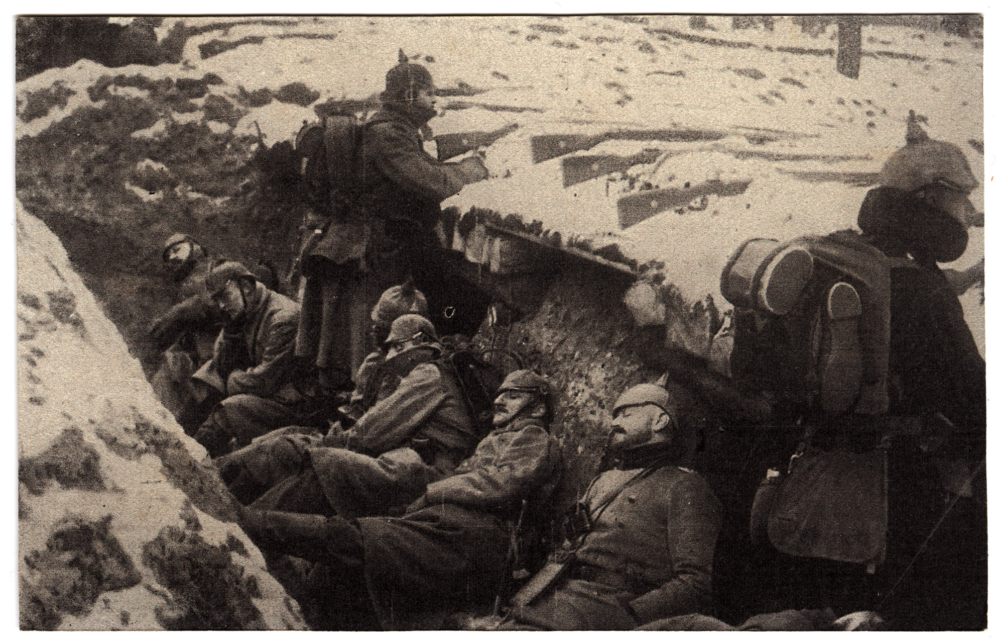 Outdoor photograph of German soldiers in a trench. It is a winter scene with heavy coats and scarves. Mauser Rifles are laid in place towards the front on top of the trench in the snow.