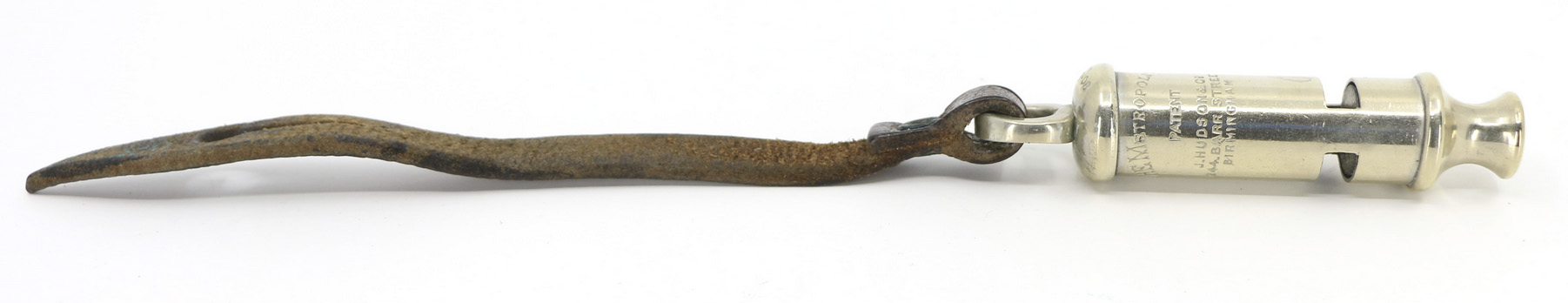 Small shiny metal cylinder with cutouts and a mouthpiece, attached to a leather strap
