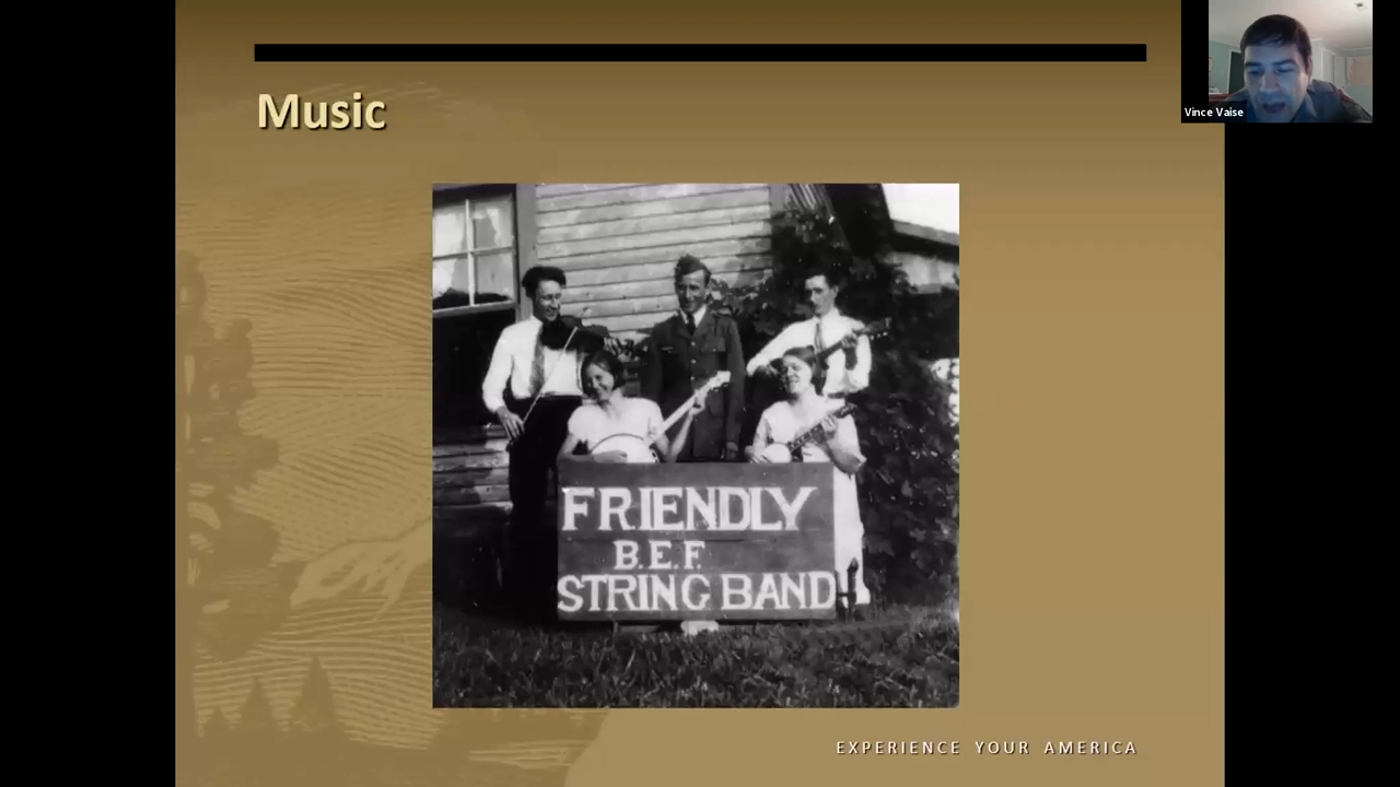Black and white photo of a group of people playing instruments. Their banner reads 'Friendly B.E.F String Band'