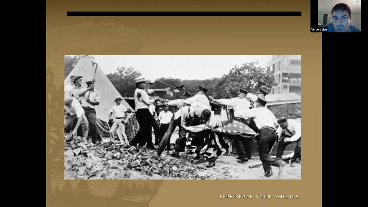 Black and white photo of men in civilian clothes and men in police uniforms rushing into a melee fist fight