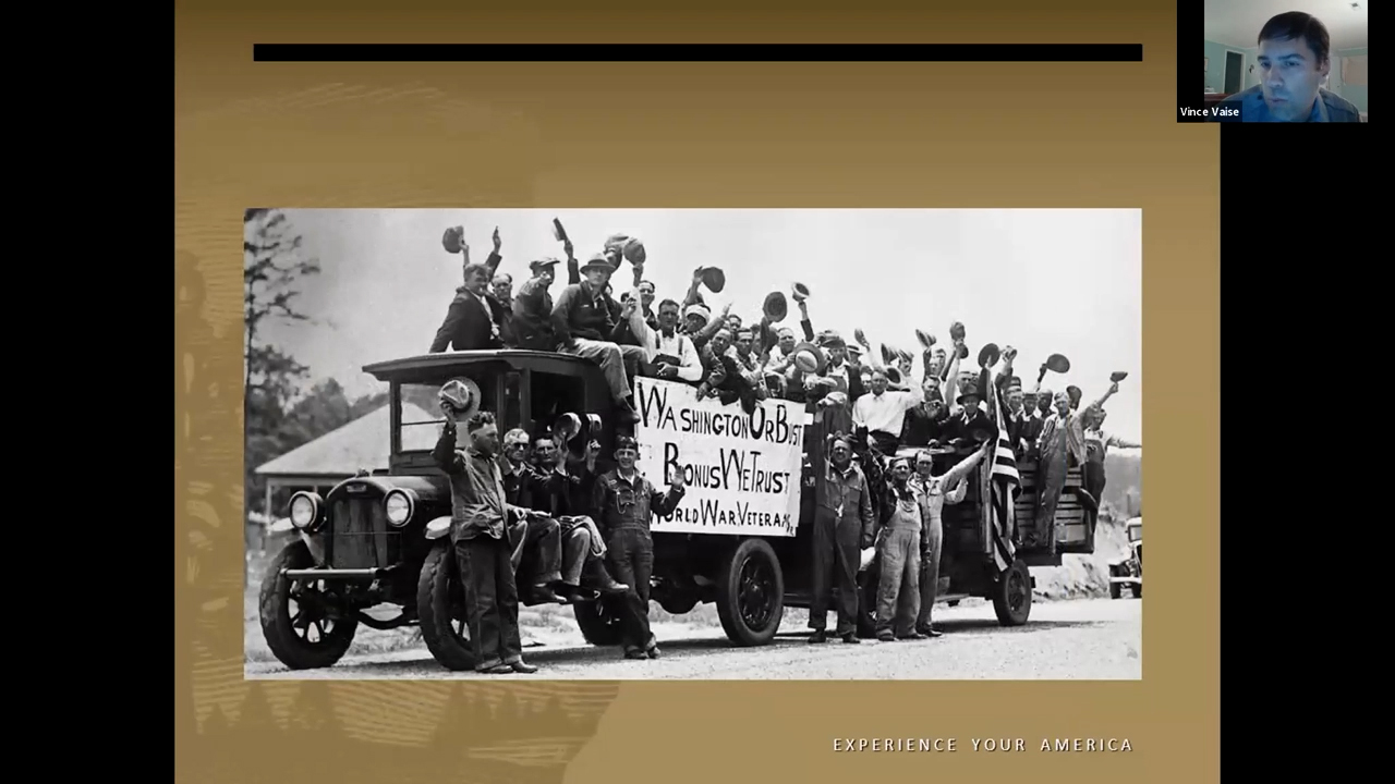 Black and white photo of 1930s trucks covered in men waving their hats