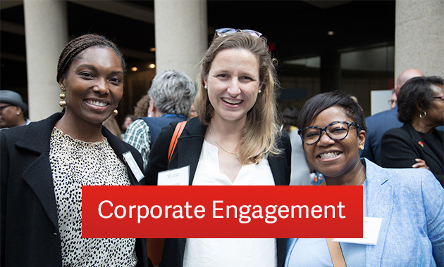 Two Black women and a white woman in business casual clothing smiling at the camera. Text: 'Corporate Engagement'