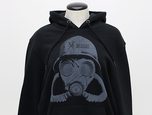 Modern photo of a black hoodie printed with a cartoon of a gas mask