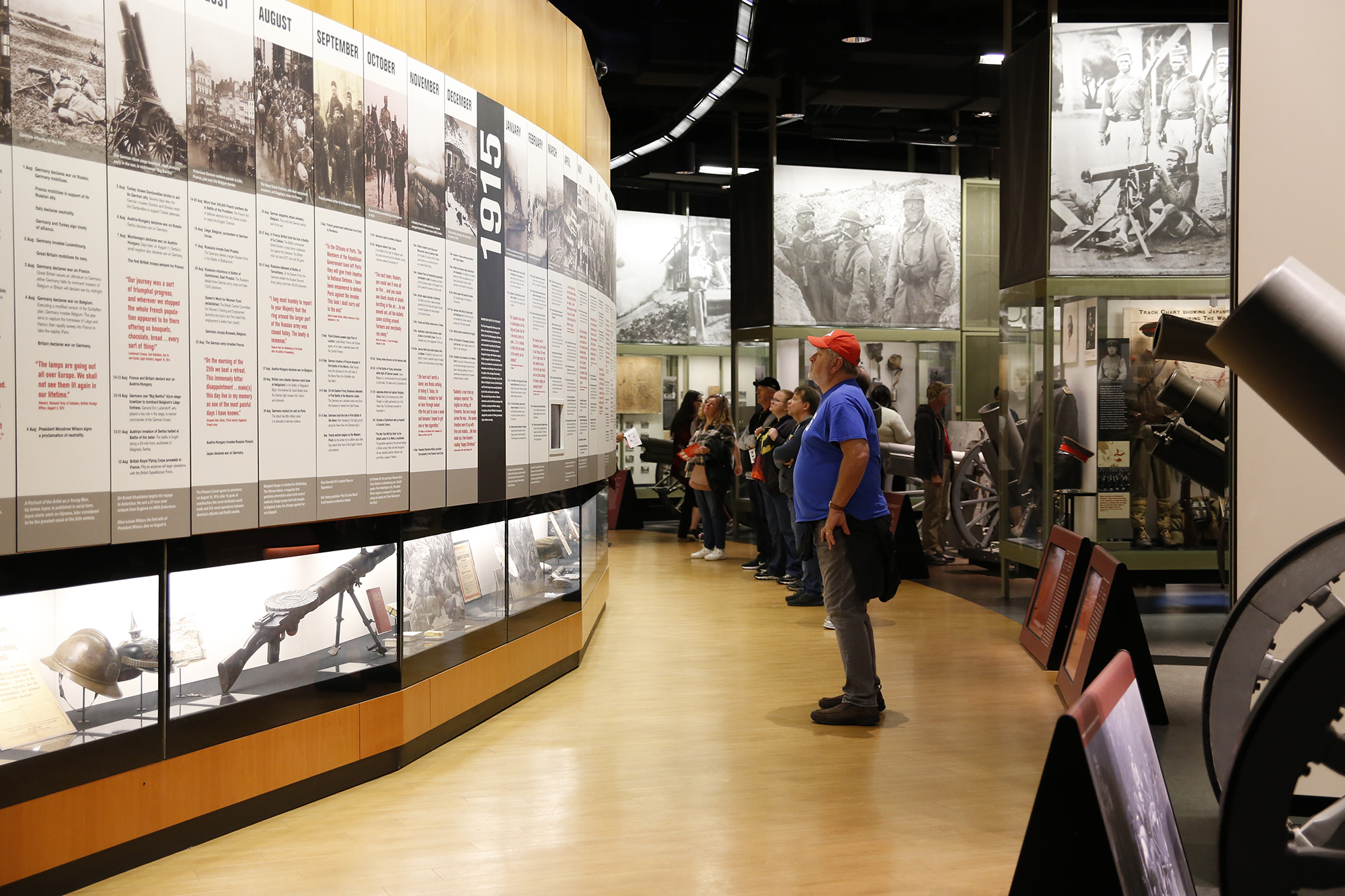 Museum gallery with a curving wall covered in text and images