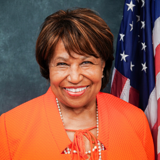 Older Black woman wearing an orange top