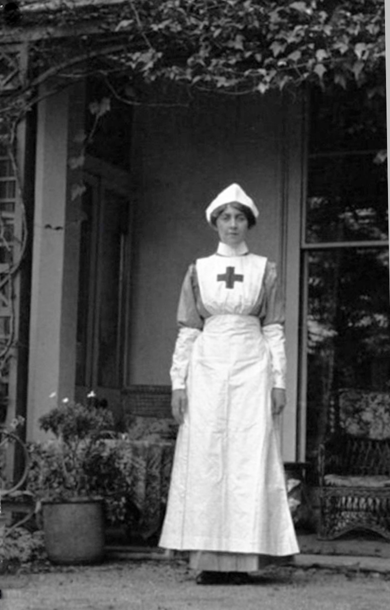 Black and white photo of a young white woman in a WWI nurse uniform