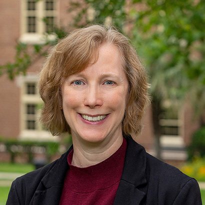 Modern photo of a white woman with light brown hair wearing a dark jacket