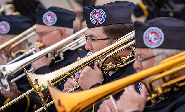 Modern photo of a row of trombonists wearing Greater Kansas City American Legion Band uniforms