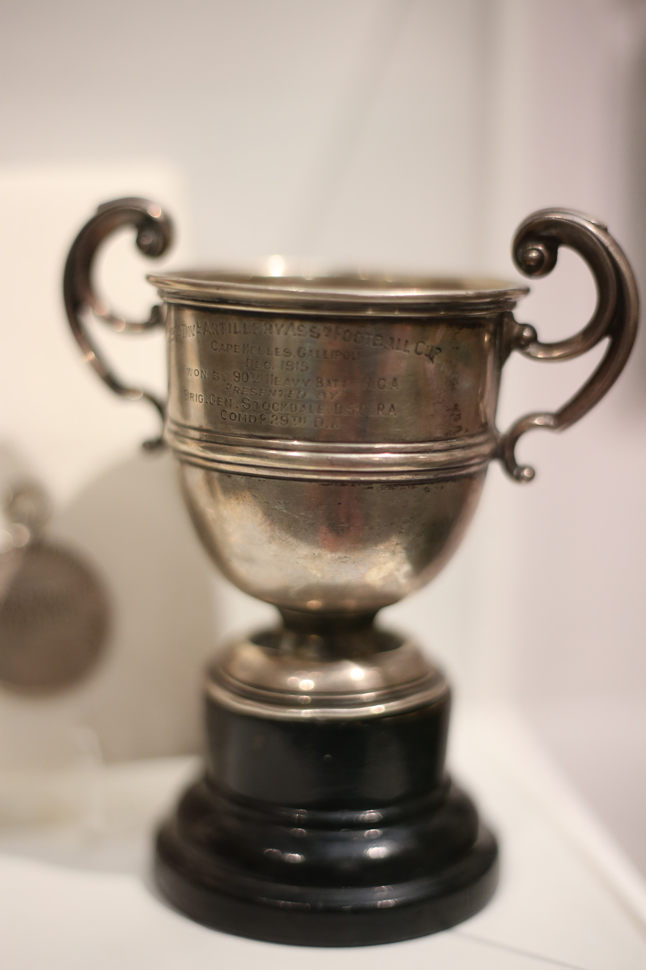 Modern photo of a small silver tropy cup engraved with calligraphy writing
