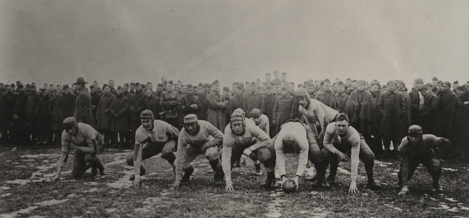 Black and white photograph of football players in an offensive formation