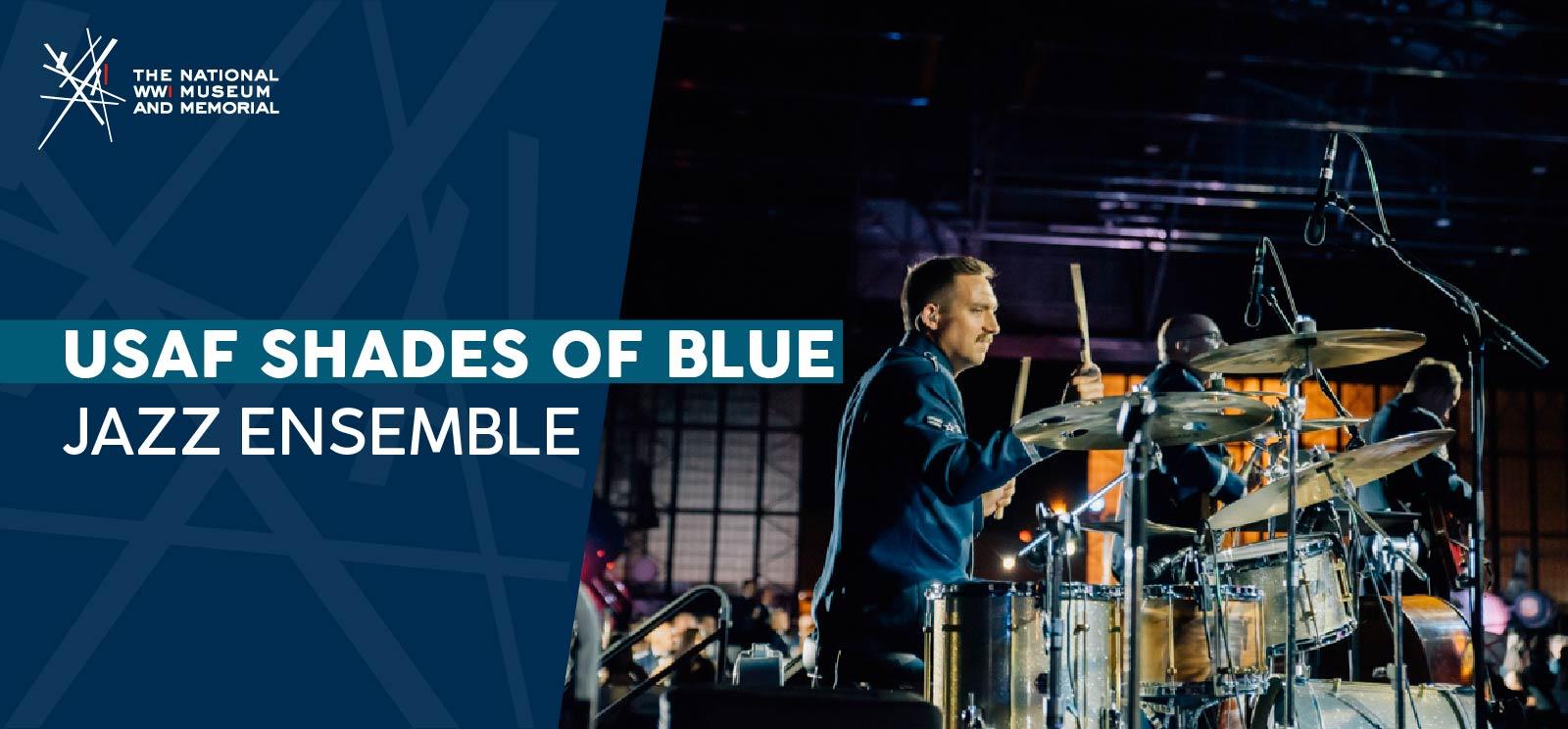 Modern photograph of a white man in a blue military uniform playing a large and complex drum set.