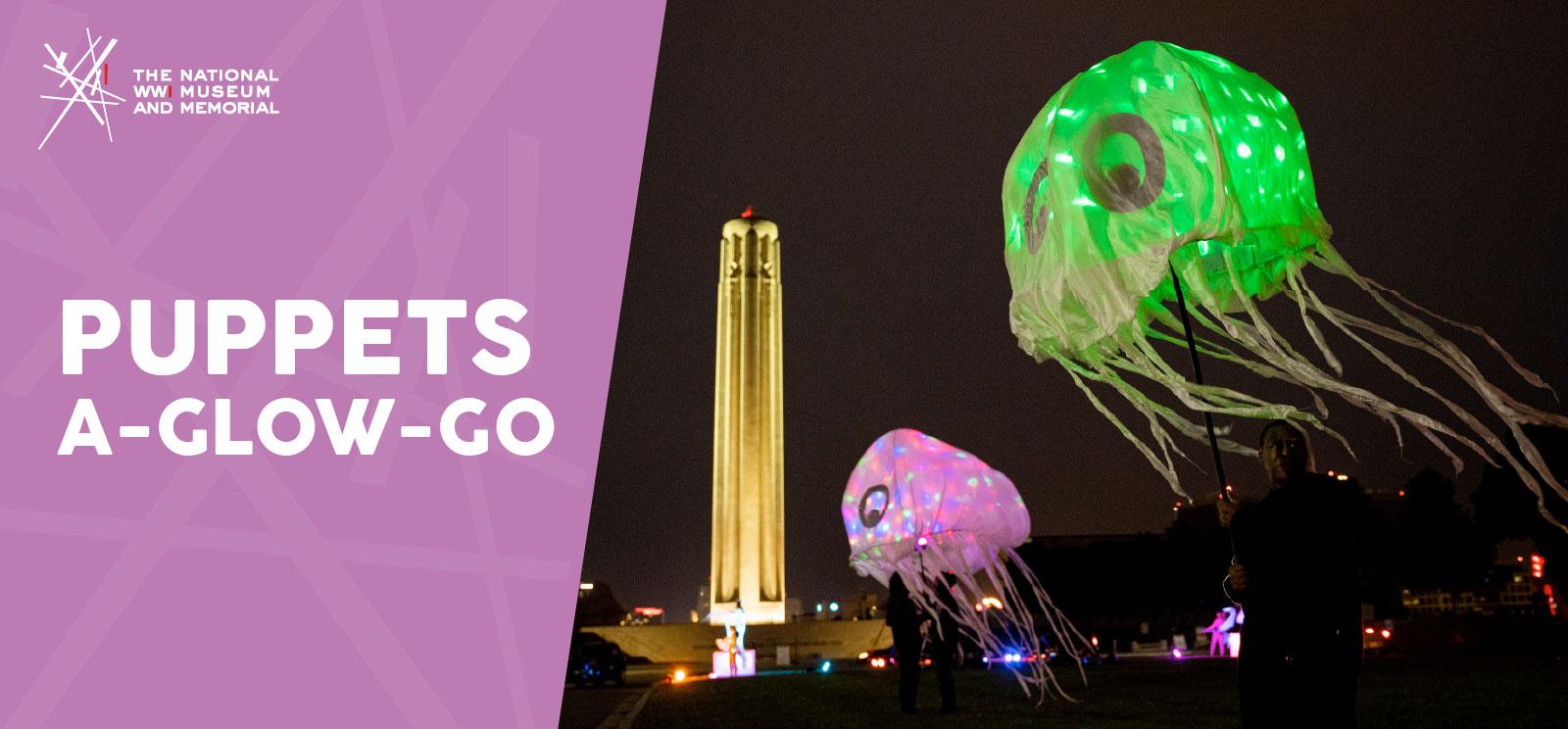 Modern photograph of giant colorful glowing jellyfish puppets floating in the air with the Liberty Memorial Tower in the background