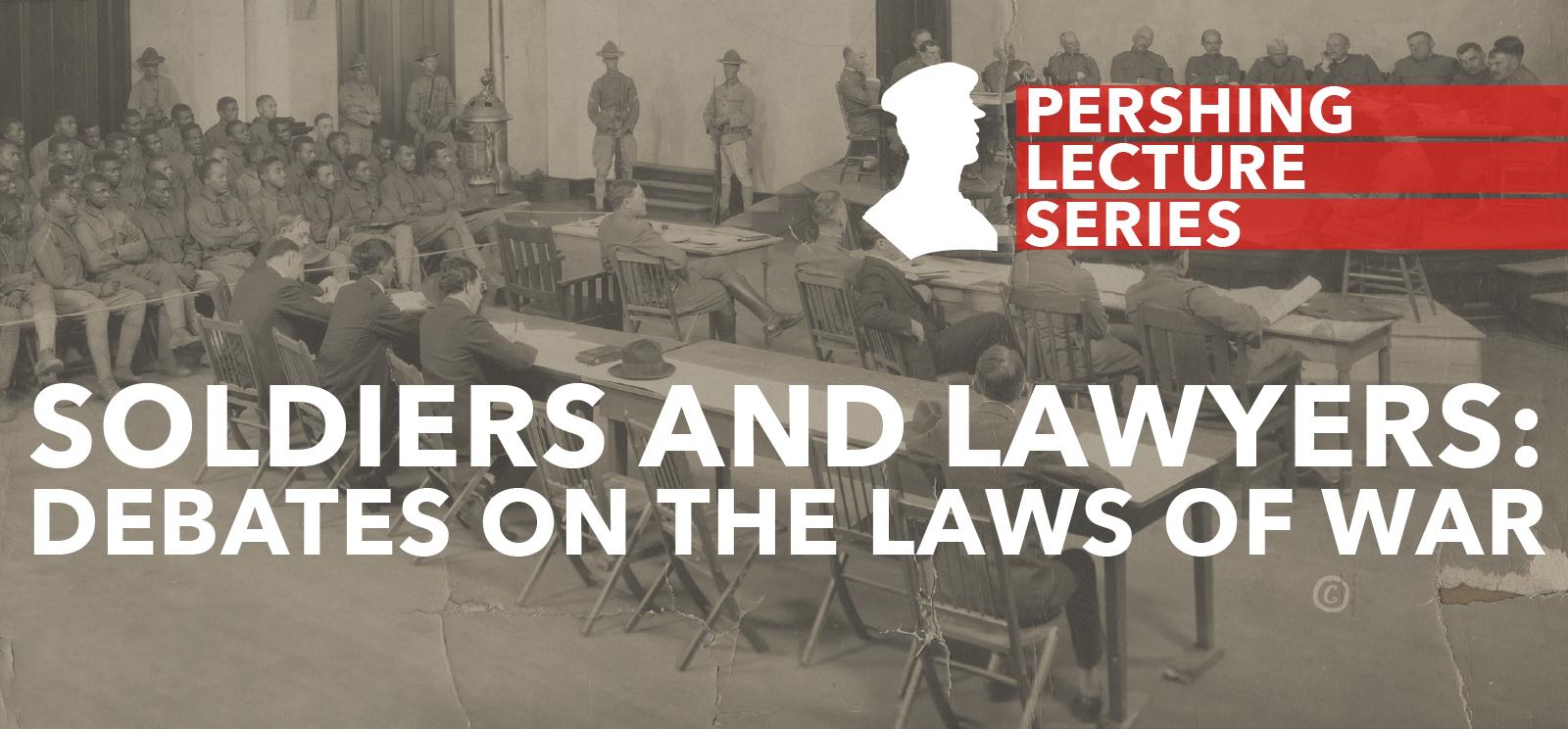 Black and white photo of a court martial trial. There are men in military uniform sitting at a table on a dais. In front of them are a couple rows of tables with more men wearing suits or uniforms. To the side are uniformed men seated in close rows.