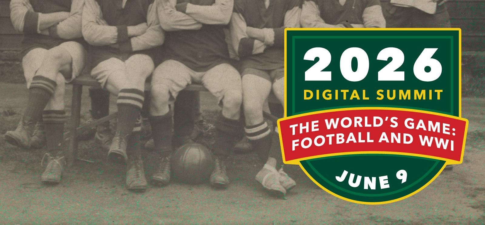 Black and white photo of seated football/soccer players. One of them has a football/soccer ball resting at his feet.