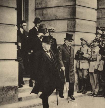 Photograph of President Clemenceau, Lloyd George and President Wilson leaving the Gallery of Mirrors at Versailles.
