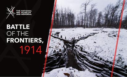 Image: Modern photograph of an intersection between two WWI trenches that cut dark grooves through a white snowy landscape. Text: 'Battle of the Frontiers, 1914'