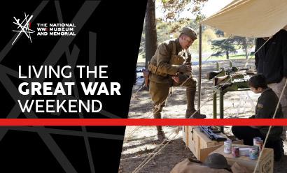 Modern photograph of a white man dressed in a WWI uniform standing under a tent shelter talking to a child in 21st-century clothes