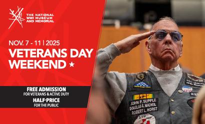 Modern photograph of an older white man wearing sunglasses and a vest covered in military patches, saluting.