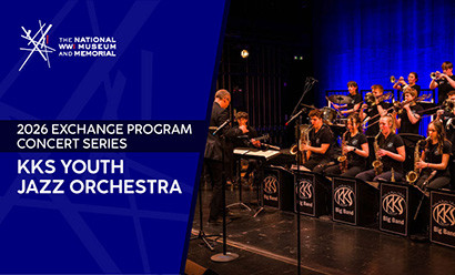 Modern photo of secondary school-aged students playing various wind and brass instruments on a stage