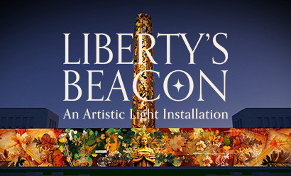 The Liberty Memorial Tower and North Wall covered in projected images of the Guardian Spirit sculptures and flower and woodland motifs