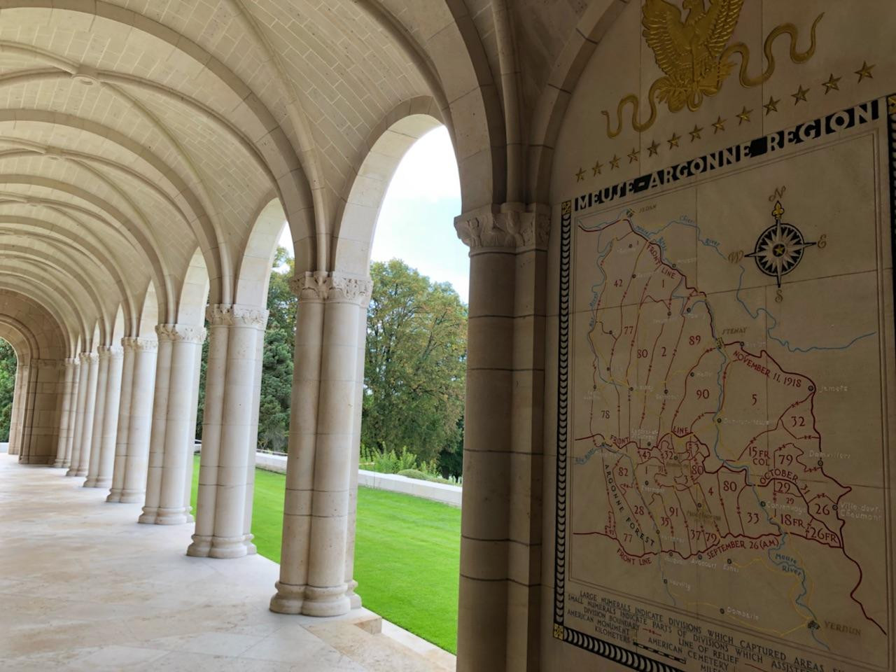 Looking out on the cemetery from a covered walkway done in white stone.