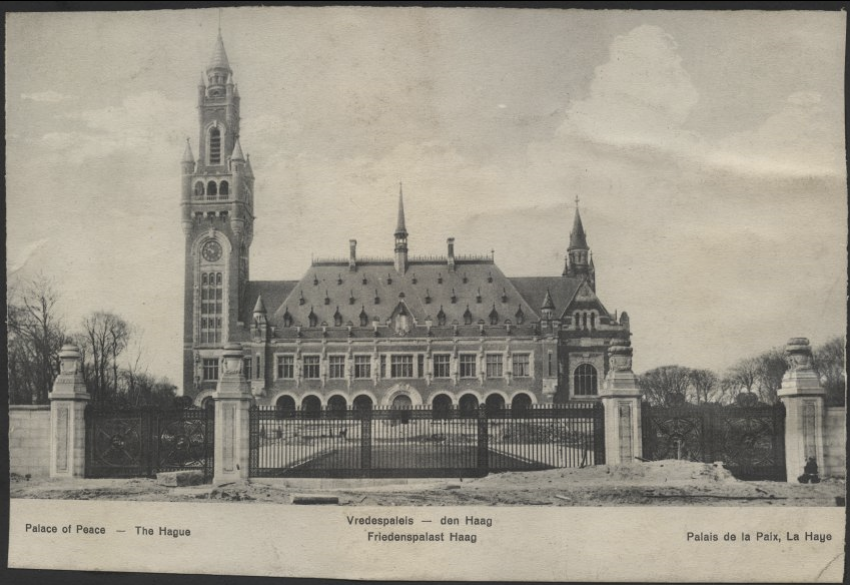 Black and white photo of a European palace surrounded by manicured lawns.