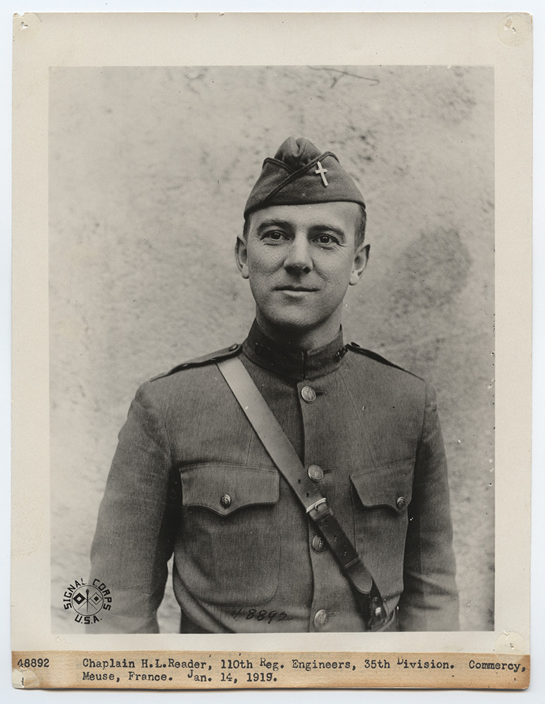Black and white photograph portrait of a white man from the waist up. He is cleanshaven and wearing a military uniform and cap.